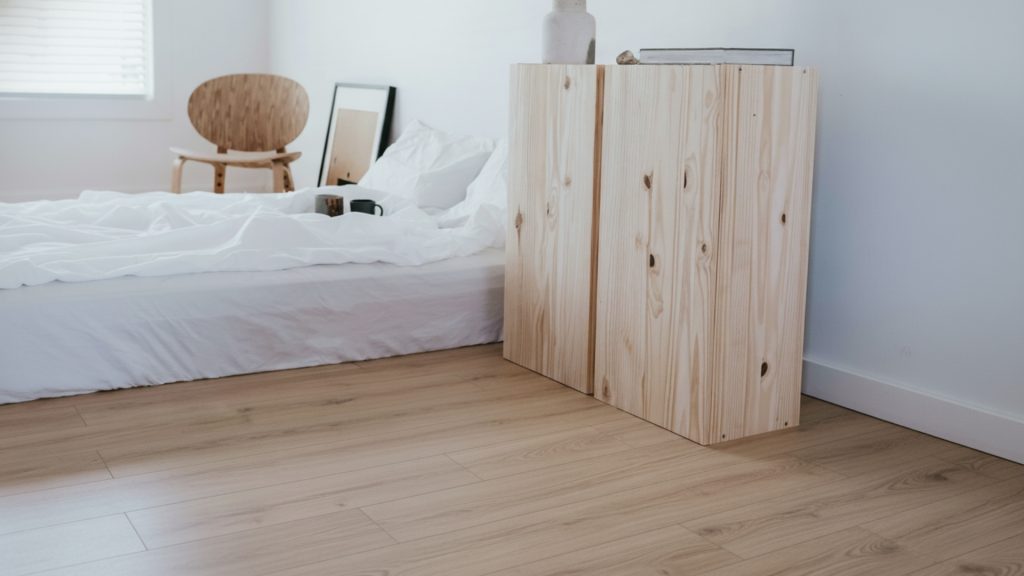 Light oak laminate flooring installed in a modern Sydney bedroom, showcasing a warm and natural timber look.